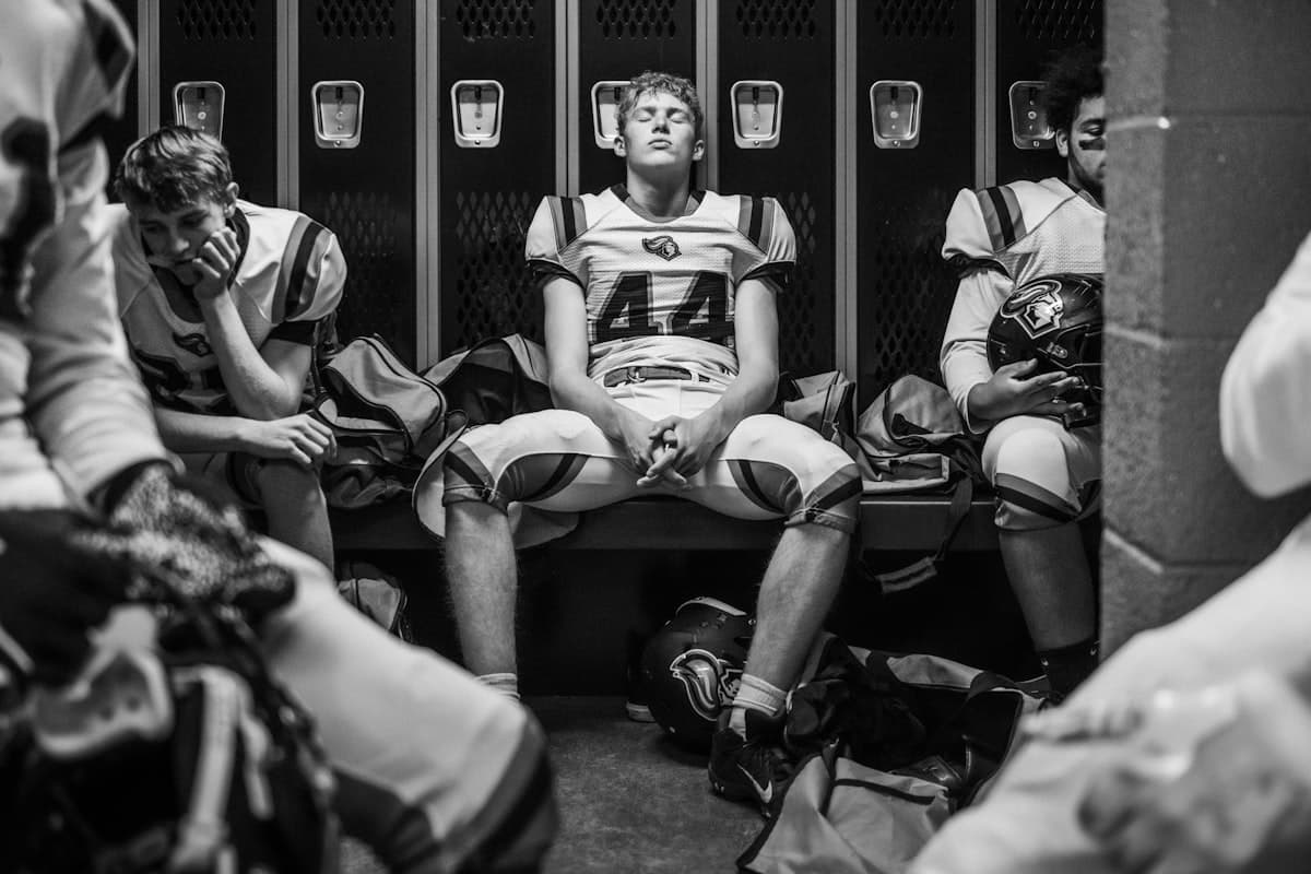 Student-athlete in a quiet, reflective moment in an empty stadium