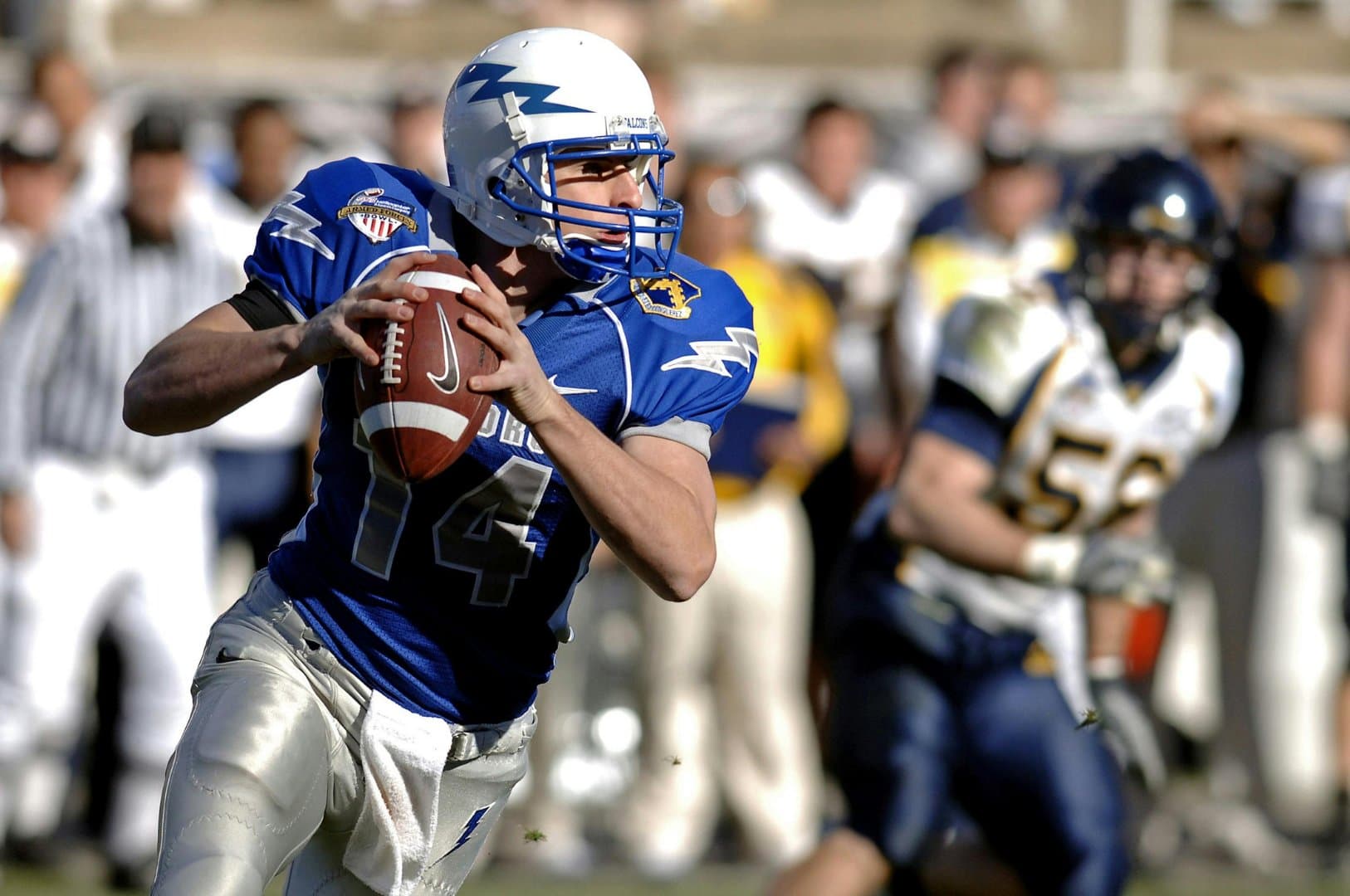 Quarterback dropping back to pass during a game