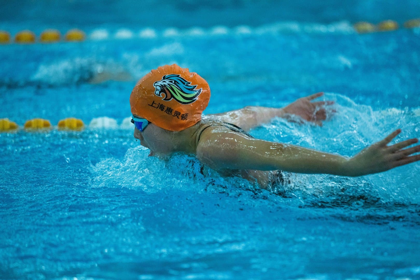 Competitive swimmer surfacing mid-stroke during the butterfly